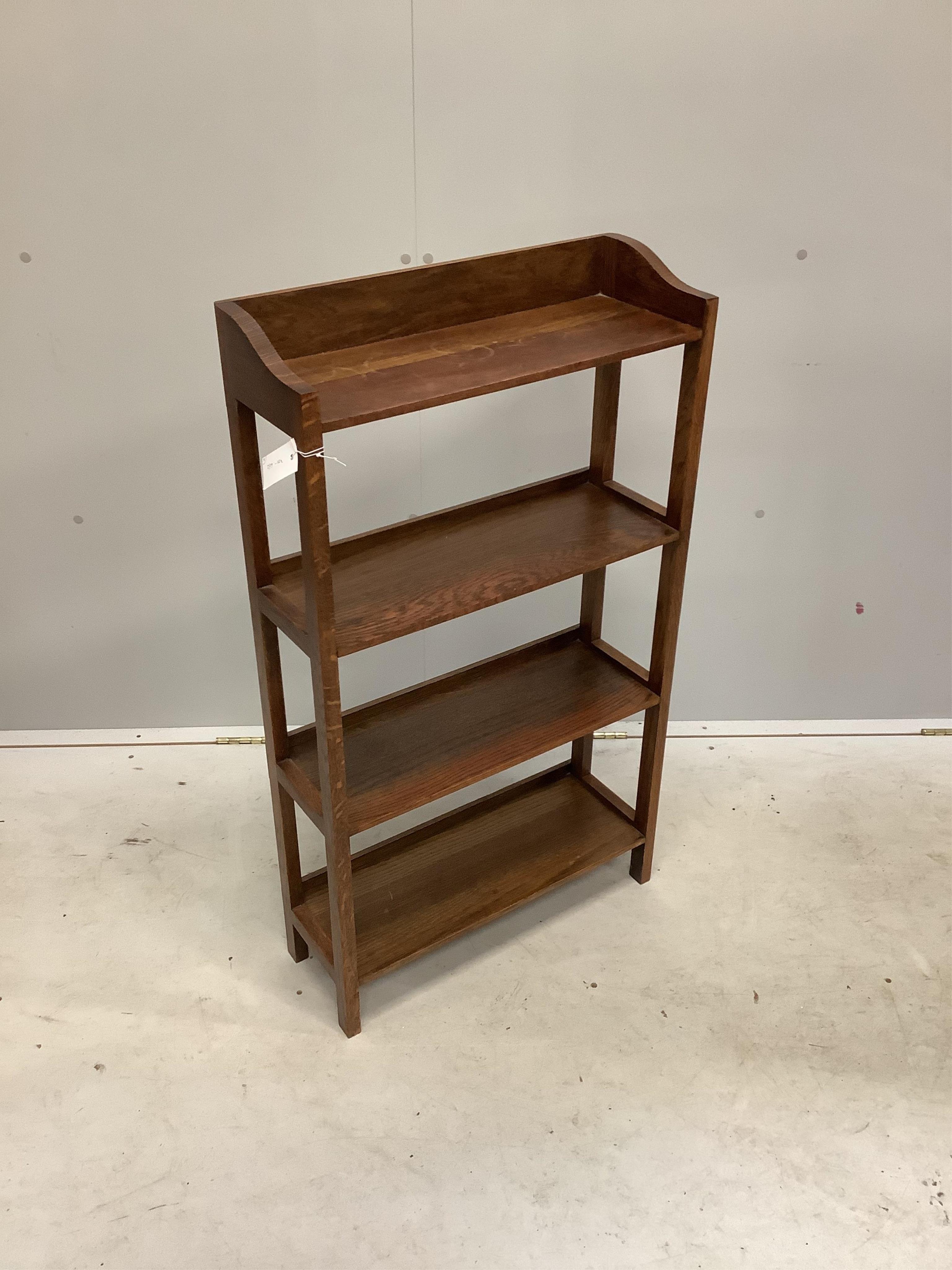 A 1930's oak lamp standard and an open bookcase, width 56cm, depth 20cm, height 98cm. Condition - good